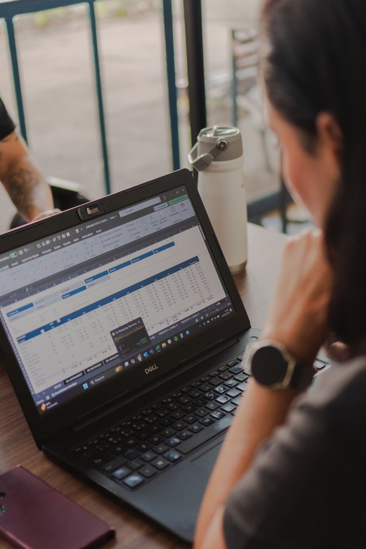 Person reviewing a spreadsheet on a laptop